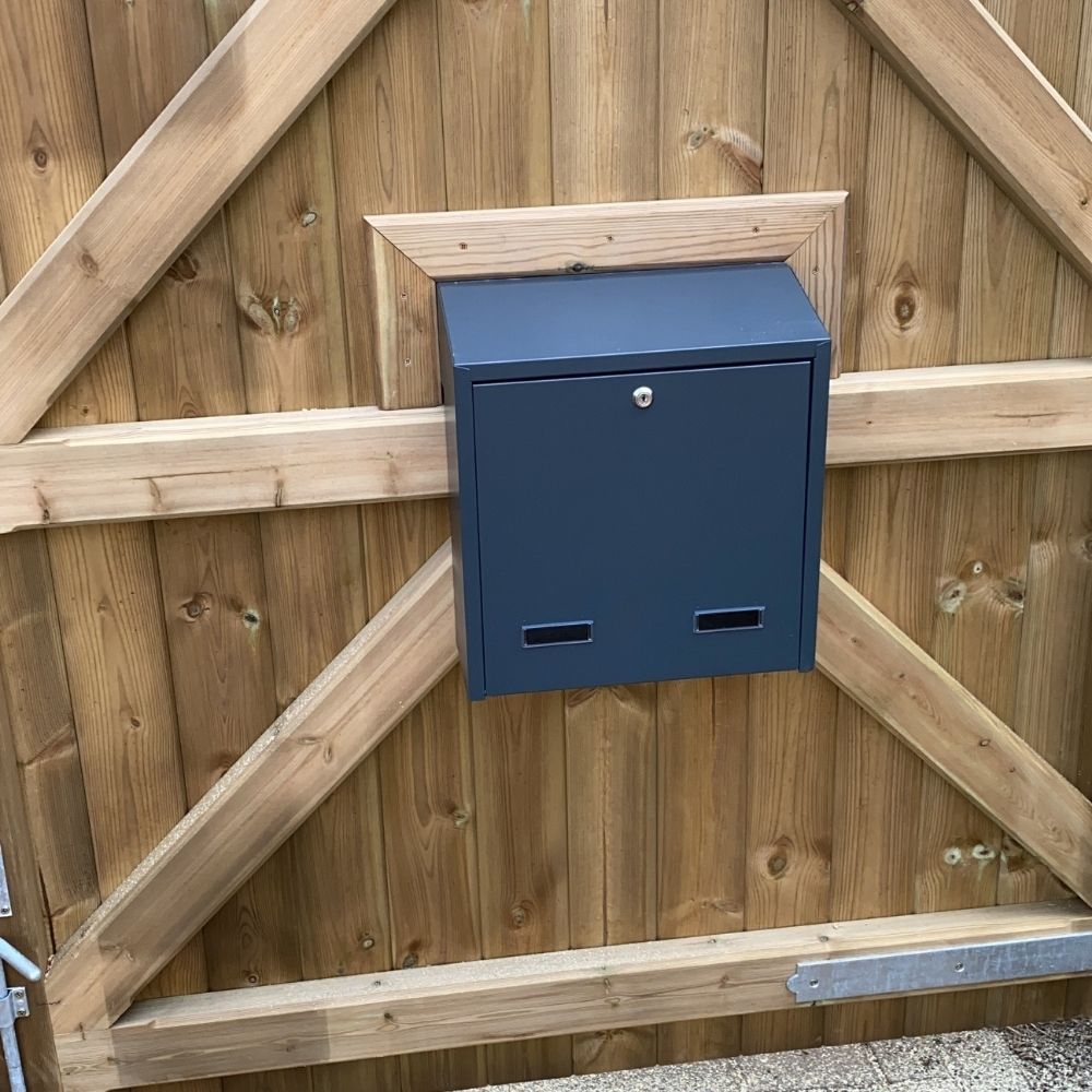 Outside letterbox in dark grey on the gate
